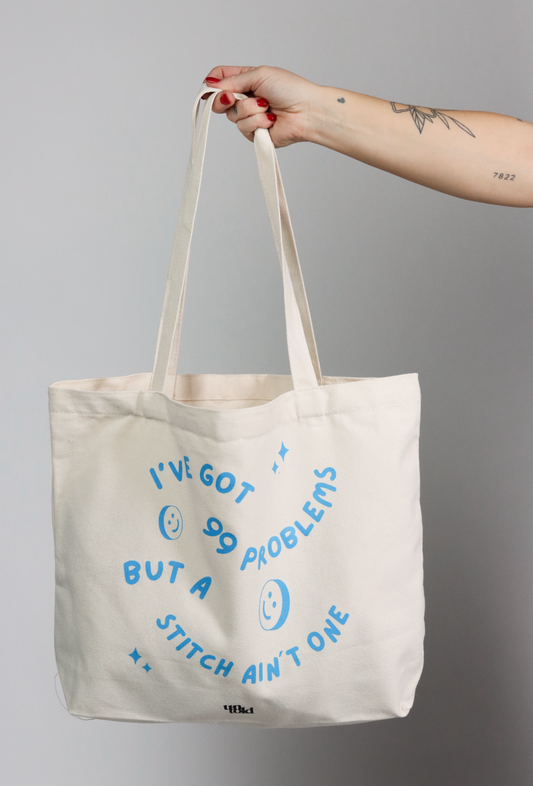 Un-told tote bag / 99 problems, but a stitch aint one